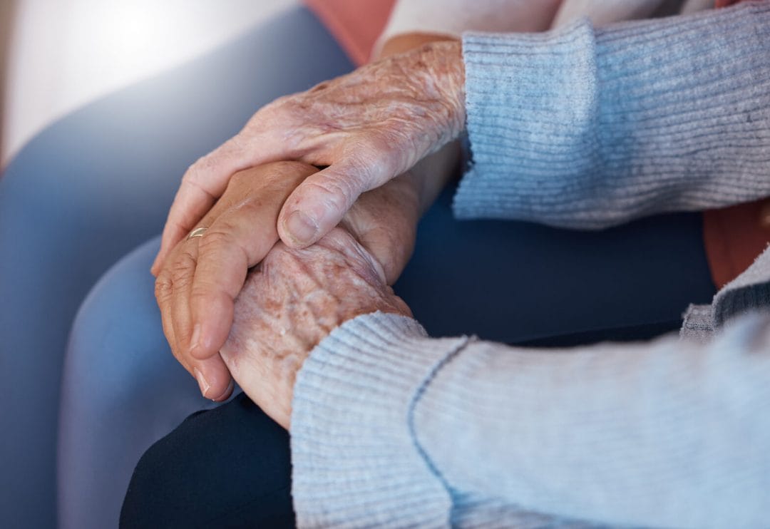 alzheimer's and dementia care -- two elderly people holding hands