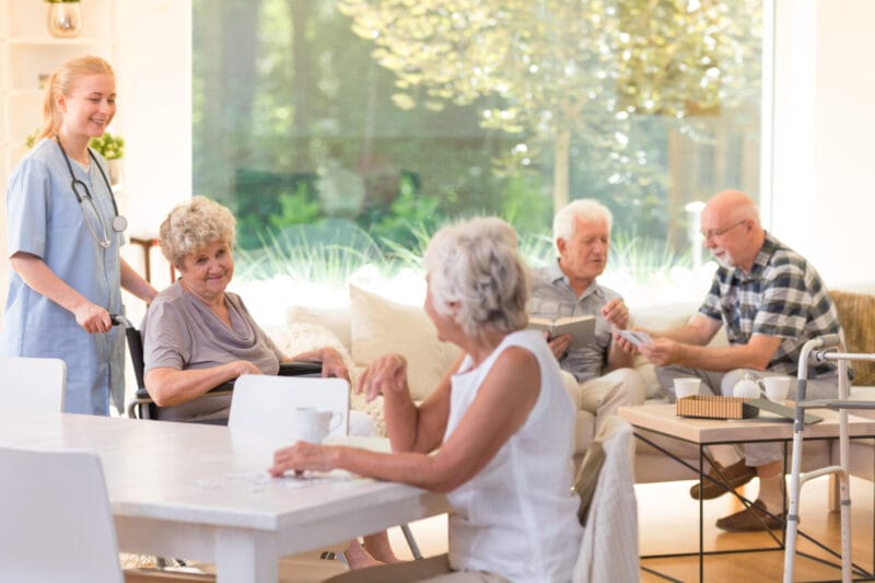 seniors in a common room of a senior living facility